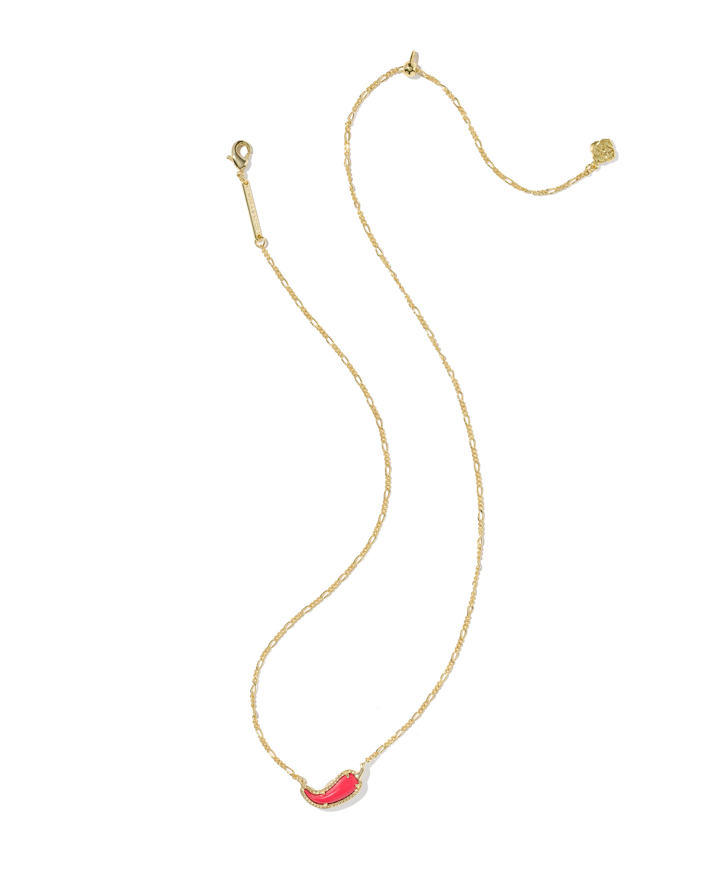 A delicate gold chain necklace featuring a small, curved red coral-like pendant, displayed on a clean white background.
