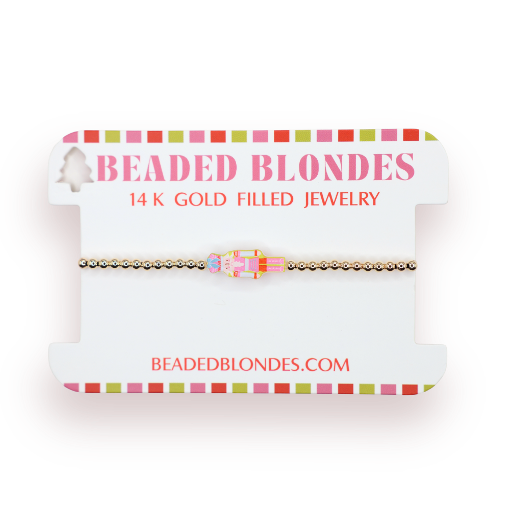 Beaded Blondes jewelry card with a nutcracker bead gold-filled bracelet on a white background