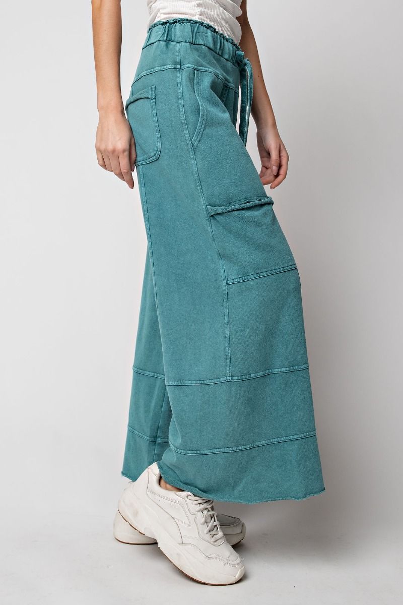 Woman wearing mineral wash pants teal green 