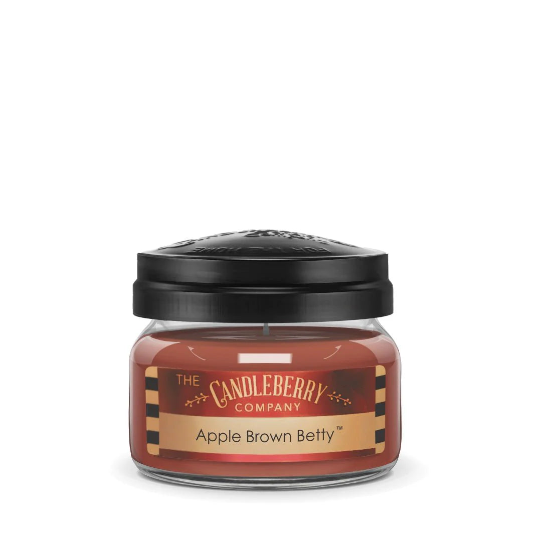 A small jar of 'Apple Brown Betty' candle wax by The Candleberry Company, with a black lid and a label that includes the product name and branding.