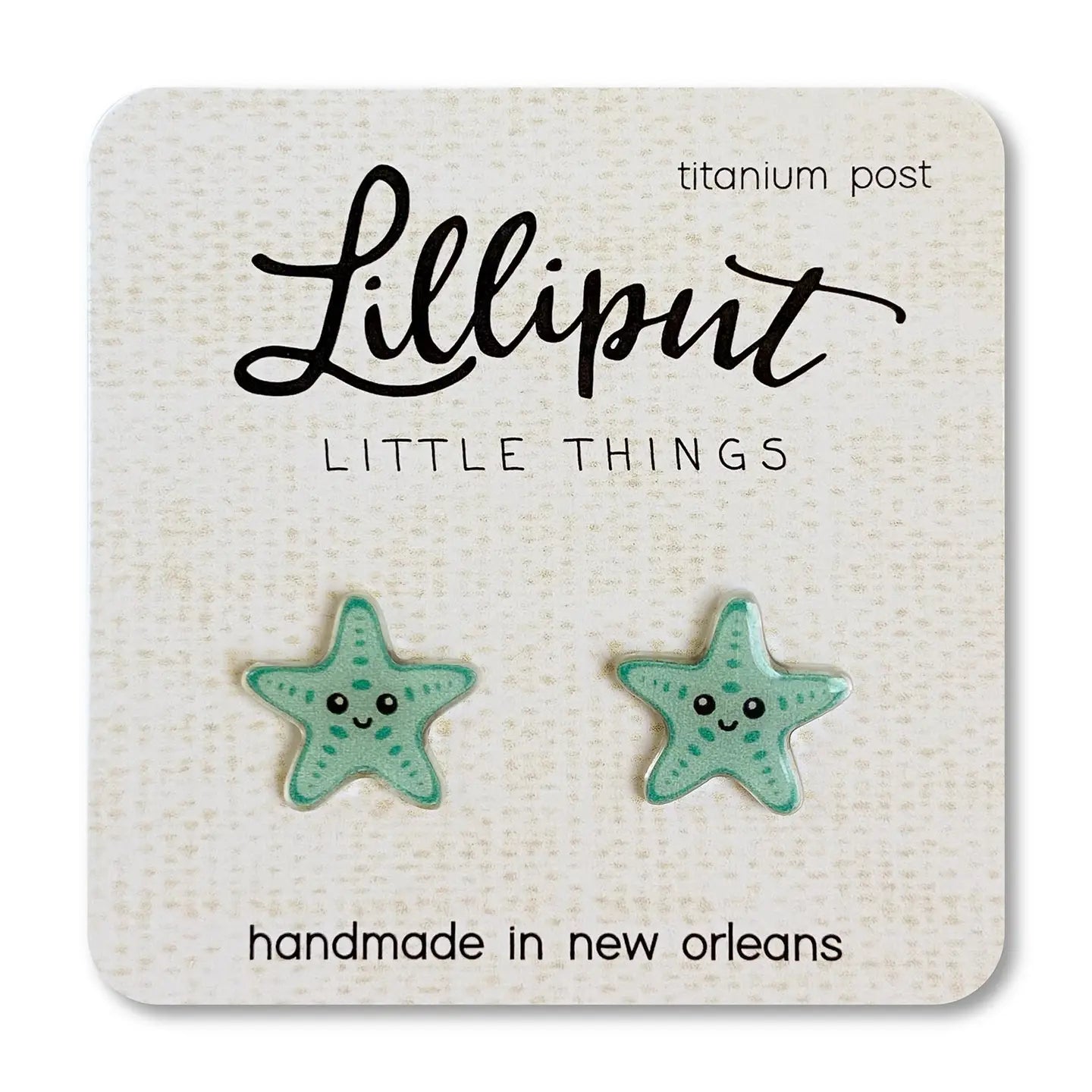 Aqua Starfish-shaped earrings on a Lilliput Little Things branded card.