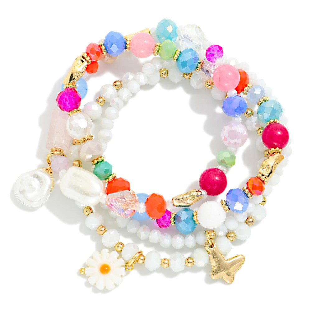 Set of colorful beaded bracelets with gold accents on a white background