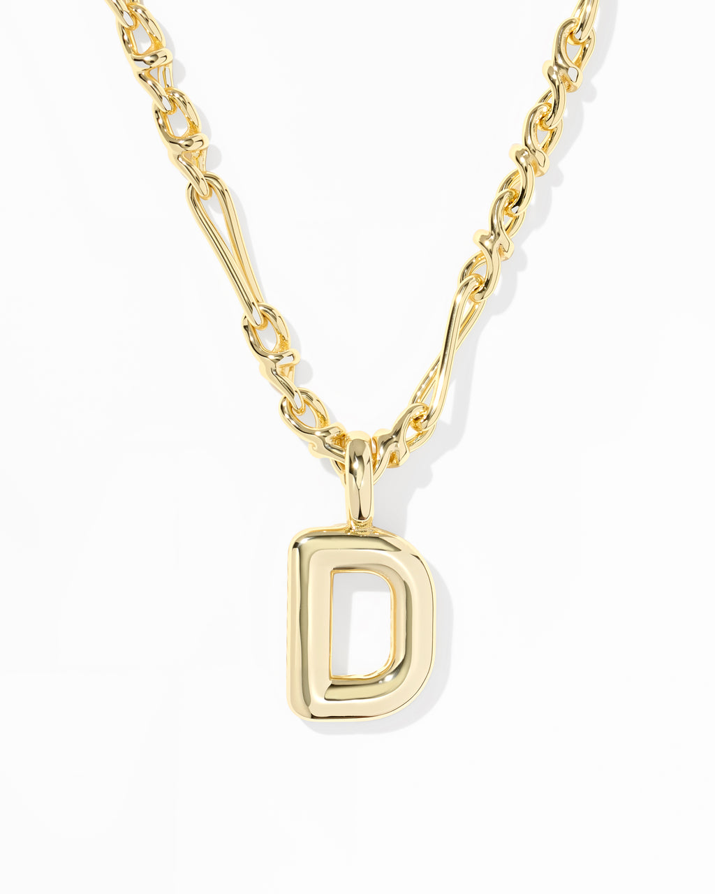 A gold initial necklace featuring a polished open capital letter 'D' pendant on a matching chain, set against a clean white background.