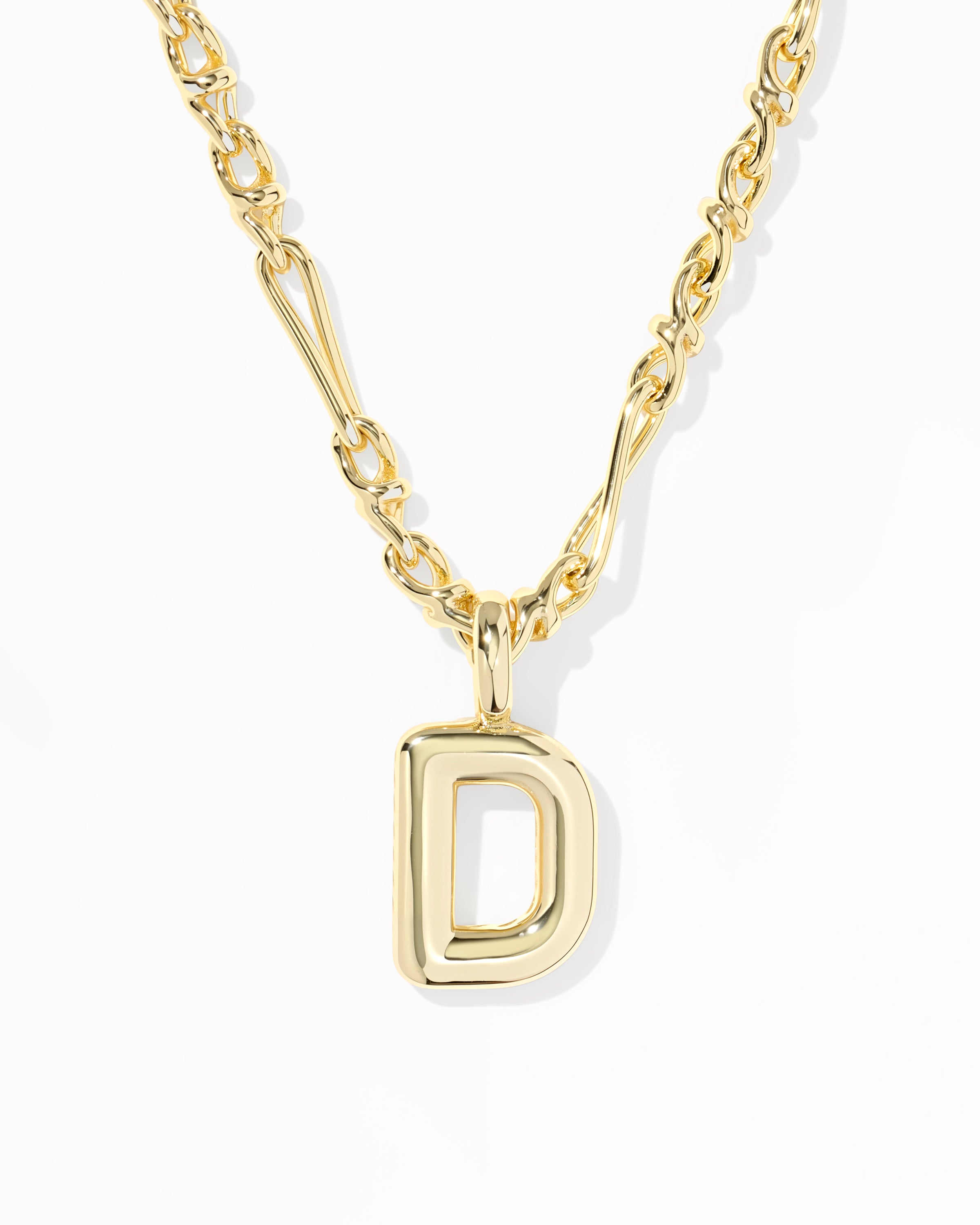 A gold initial necklace featuring a polished open capital letter 'D' pendant on a matching chain, set against a clean white background.