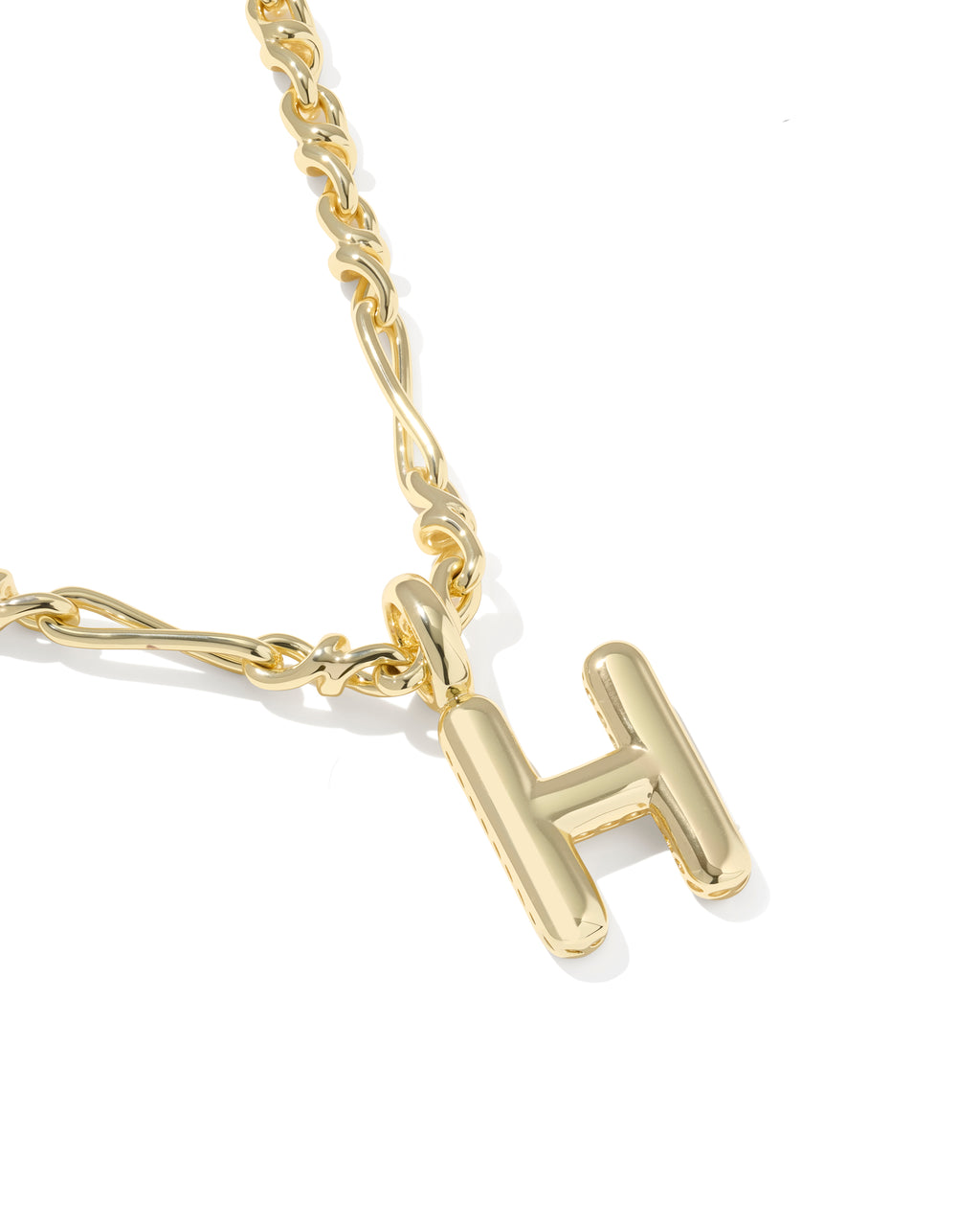 Gold necklace with a 'H' pendant on a white background
