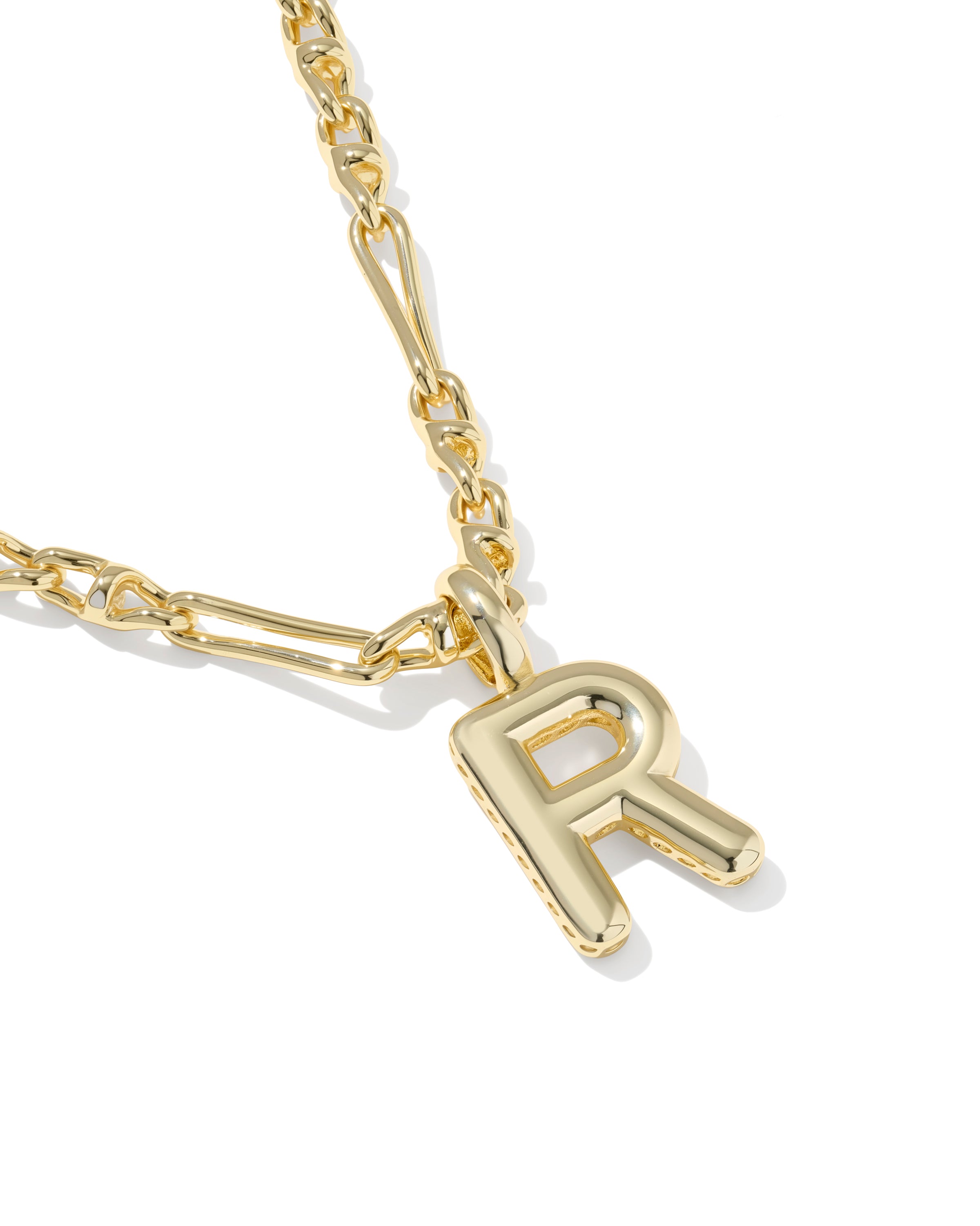 A close-up of a gold chain necklace featuring a polished, openwork capital letter 'R' pendant, set against a clean white background.