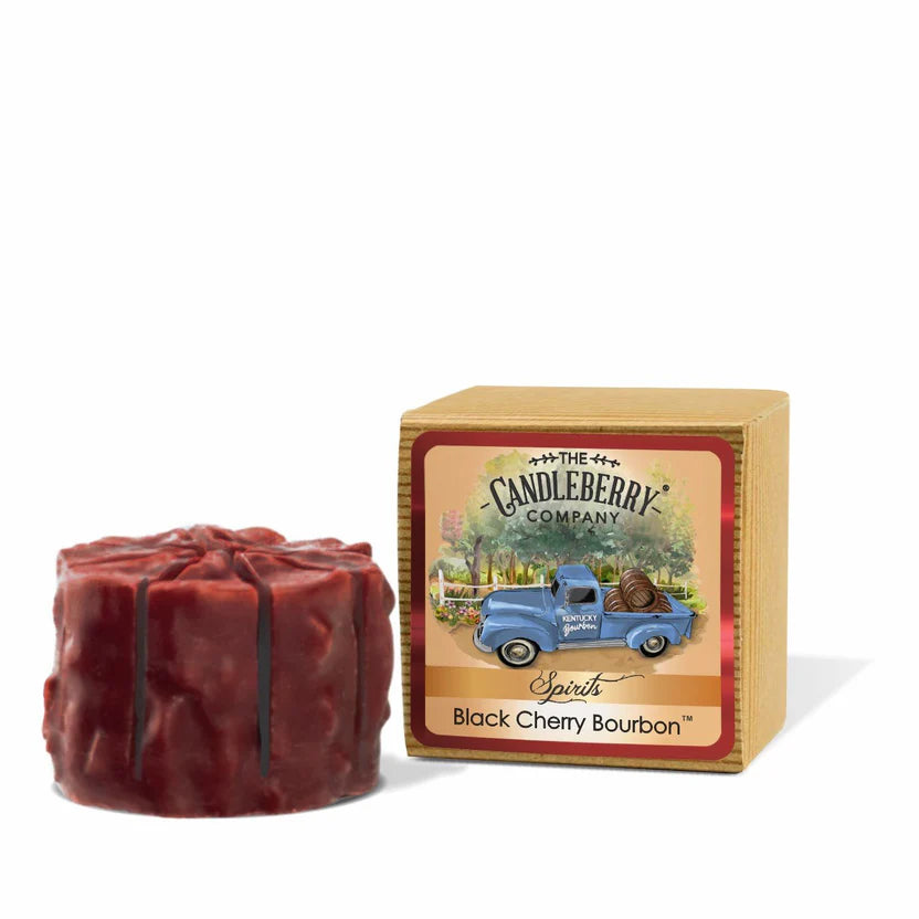 A red candle wax melt in the shape of a tart, next to its packaging box which has 'Candleberry Company' branding and the scent name 'Black Cherry Bourbon'.