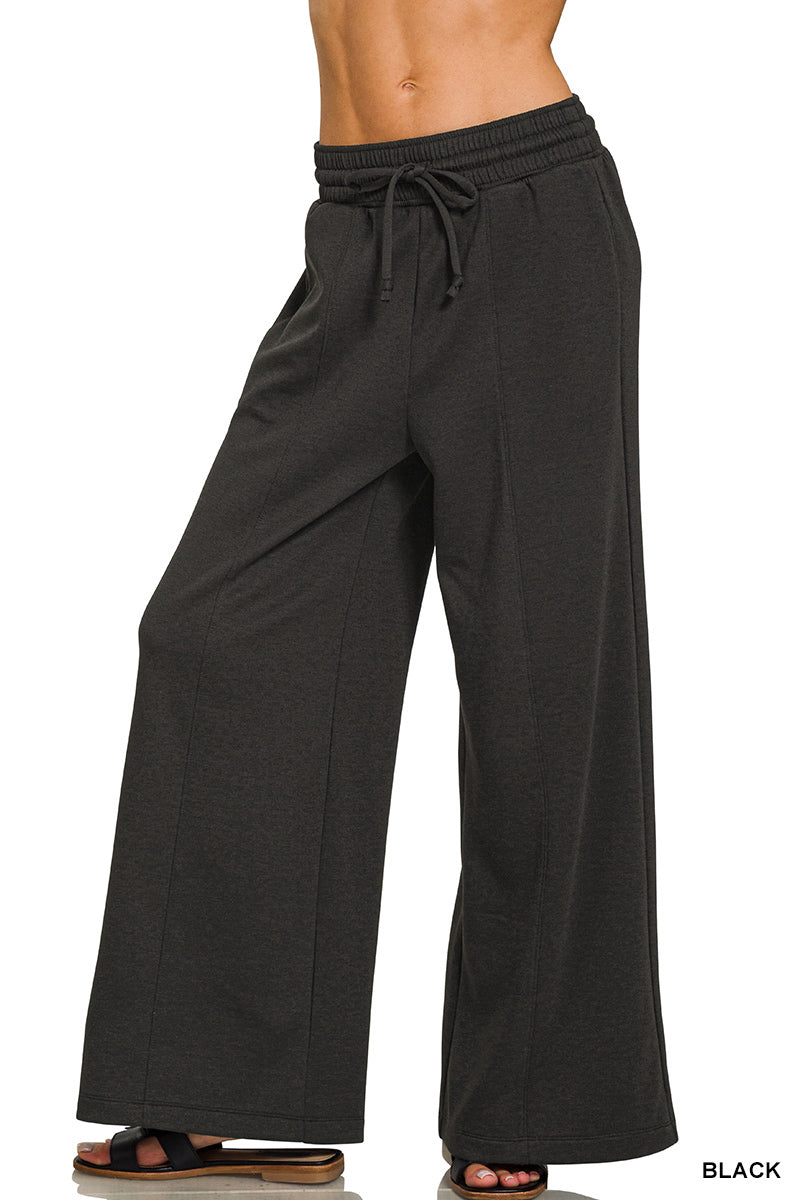 Black wide-leg pants with drawstring waist on a white background