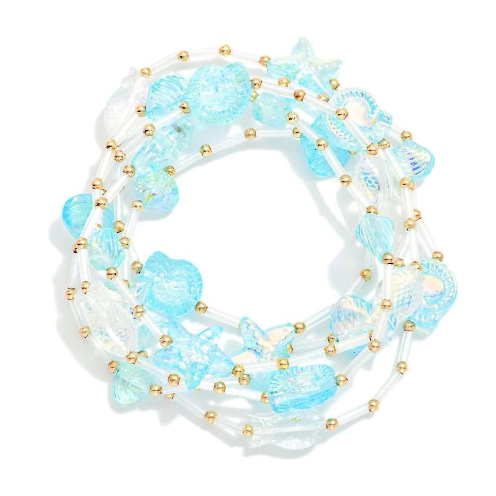 Blue bracelet set with seashells and starfish on a white background 