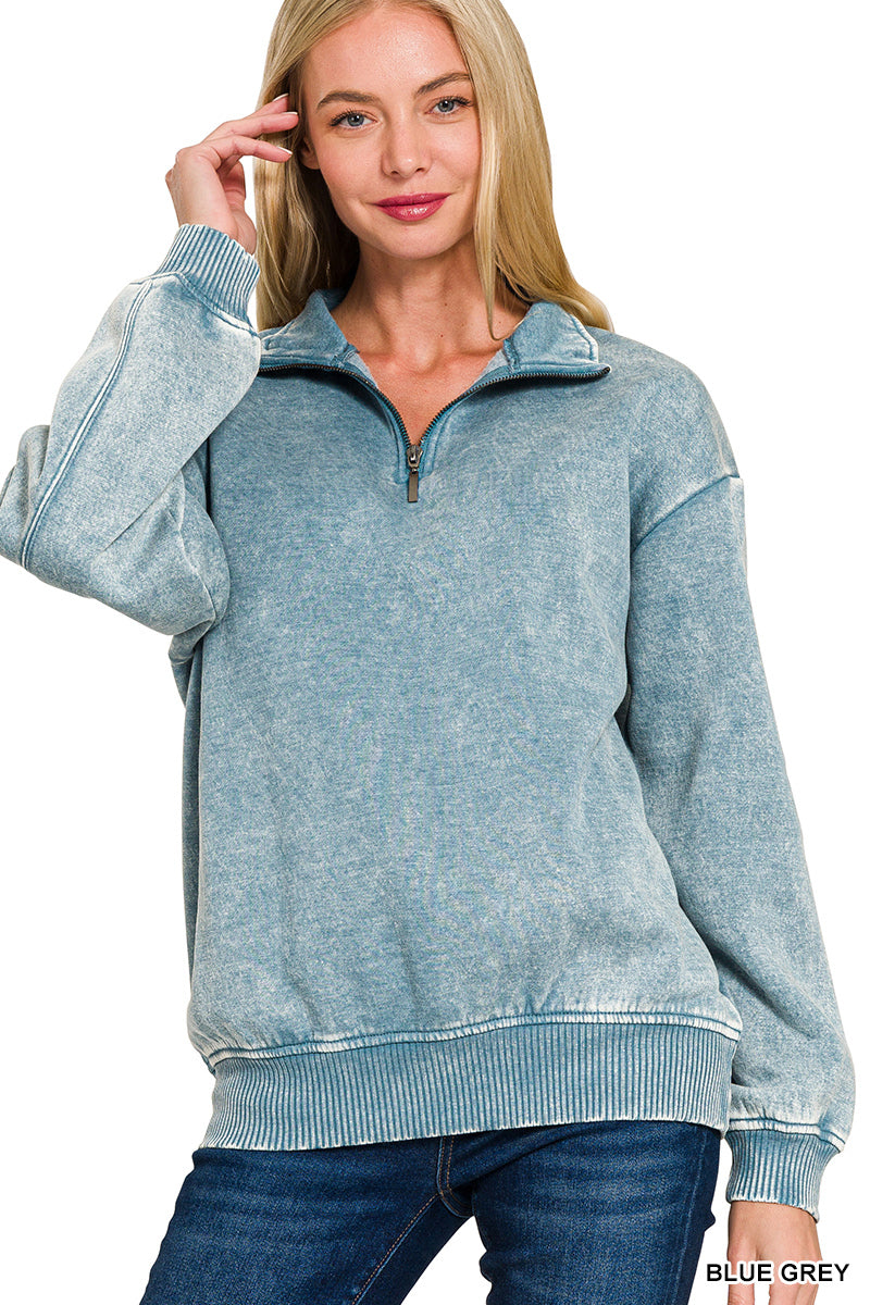 Woman wearing a blue-grey pullover with a white background
