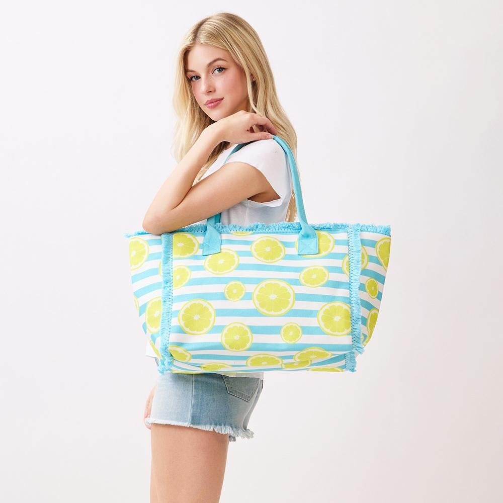 Woman holding a tote bag with lemon pattern on a white background