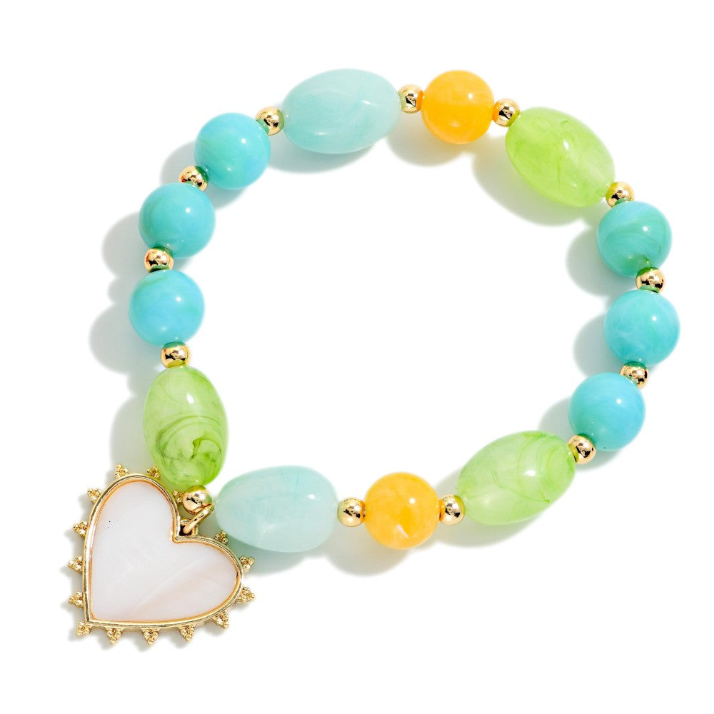 Colorful beaded bracelet with a heart charm on a white background