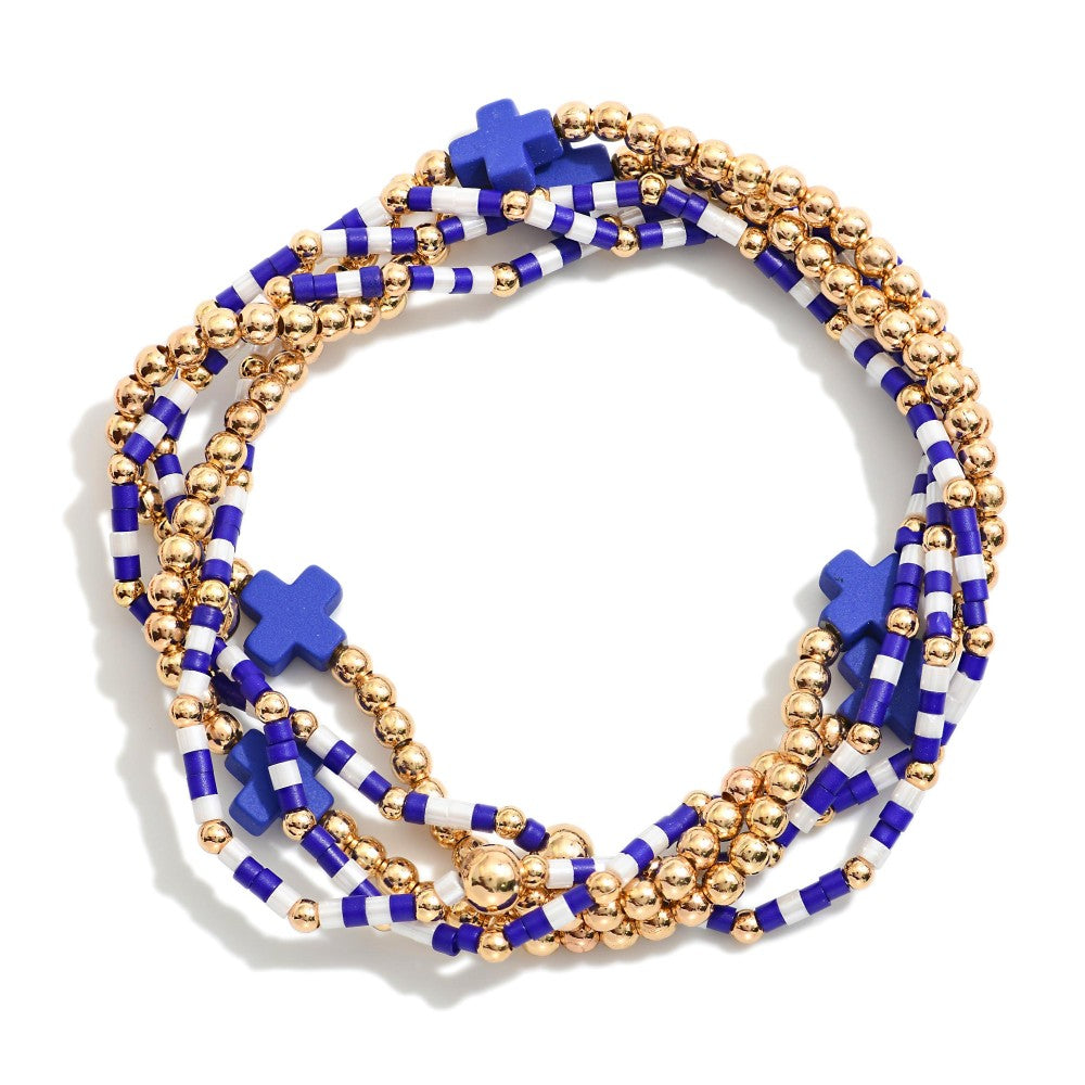 Stack of beaded bracelets with blue and gold accents on a white background