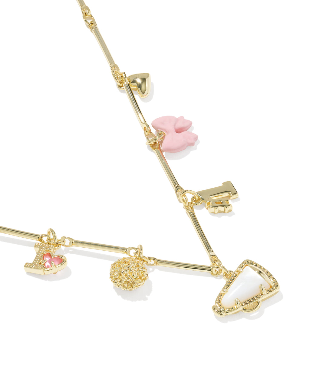 A gold charm bracelet featuring multiple whimsical charms, including a pink bunny, a key, a small pink gem heart, a textured gold ball, and a clear rhinestone-trimmed heart, displayed on a clean white background.