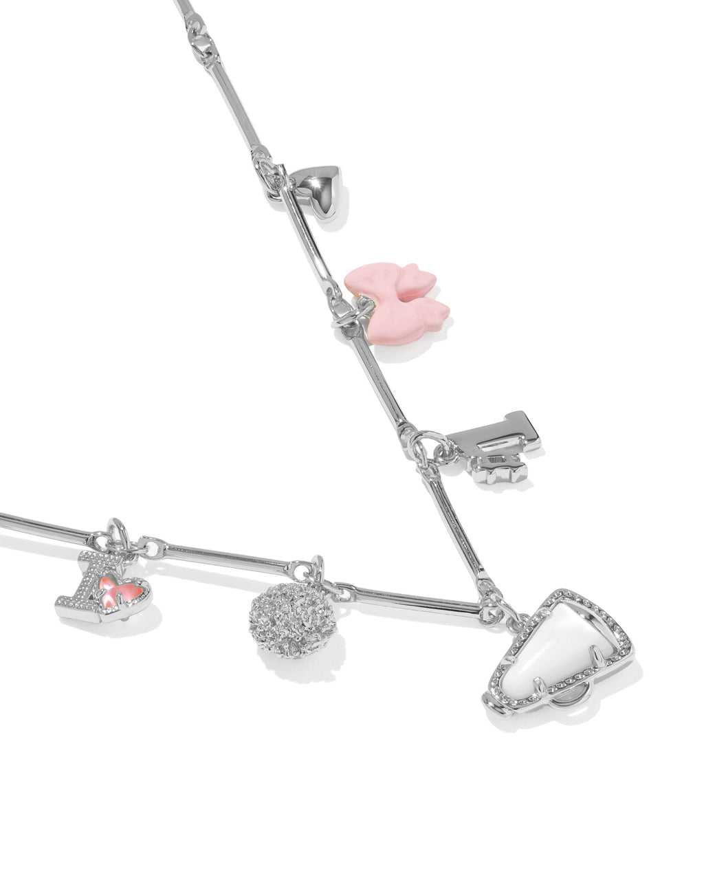 A silver-toned charm bracelet featuring multiple dangling charms, including a pink heart-shaped charm, a small silver key charm, a heart with a pink gem, a round textured charm, and a triangular charm, displayed on a clean white background.
