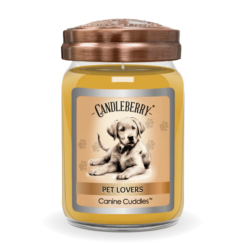 A jar candle with a dog picture on the label, titled 'Pet Lovers Canine Cuddles', with a copper-colored lid.