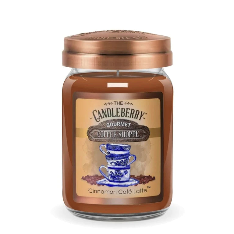 A jar candle with a label depicting two blue cups and the text 'Cinnamon Café Latte', with a copper-colored lid on top.