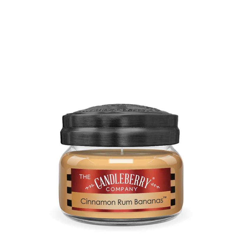 A small jar candle with a black lid, labeled 'Cinnamon Rum Bananas' from The Candleberry Company.