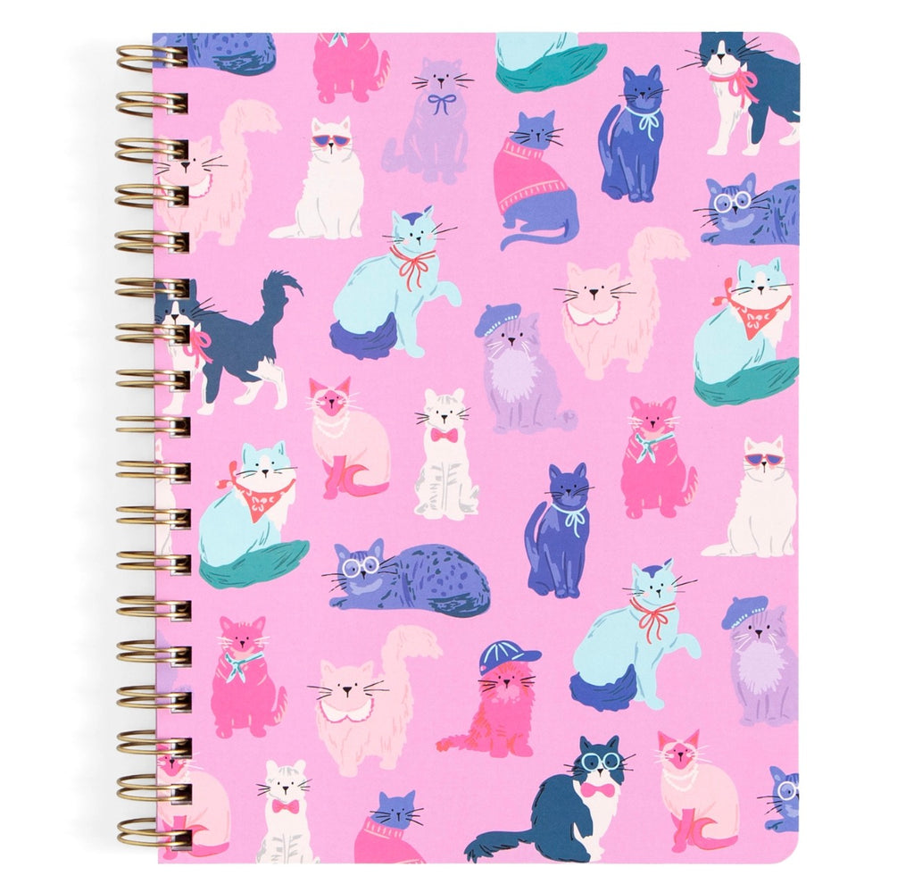 A spiral-bound notebook featuring a pink cover decorated with a colorful cartoon cat pattern, bound with gold-toned metal wire on the left side.
