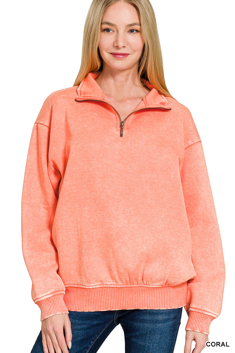 Woman wearing a coral pullover with a white background