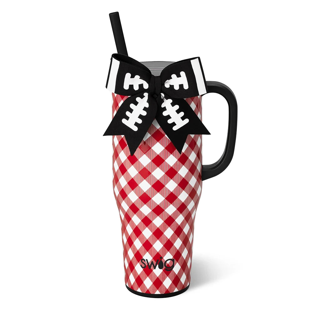 A red and white gingham patterned insulated tumbler with a black handle, black straw, and a decorative black bow with white football laces on the front. The SWO brand name is printed near the bottom.
