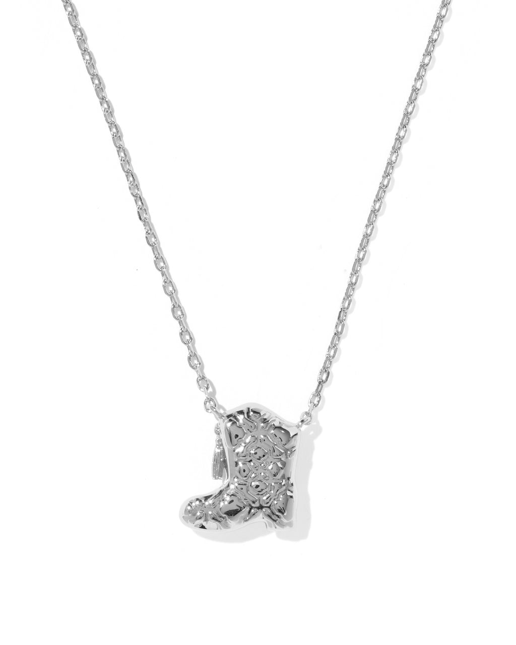 A silver-toned necklace featuring a small boot-shaped pendant paved with clear stones, shown against a plain white background.