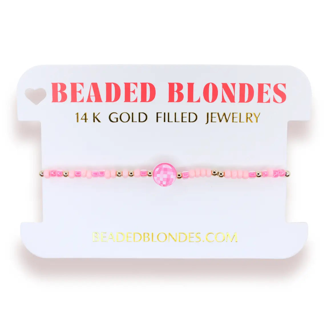 A pink beaded bracelet with a central pink gemstone and gold-filled beads, displayed on a white jewelry card labeled 'BEADED BLONDES'.