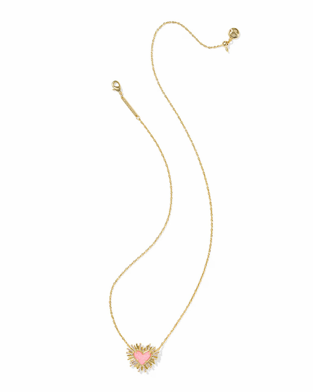 A delicate gold chain necklace featuring a small heart-shaped pendant with a light pink center and a gold sunburst halo, displayed on a clean white background.