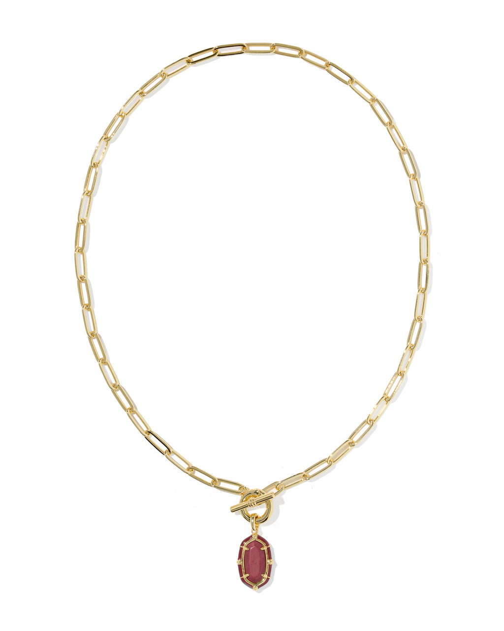 A gold paperclip chain necklace with a toggle clasp and a small oval pendant featuring a dark red center stone surrounded by a gold border, shown on a plain white background.