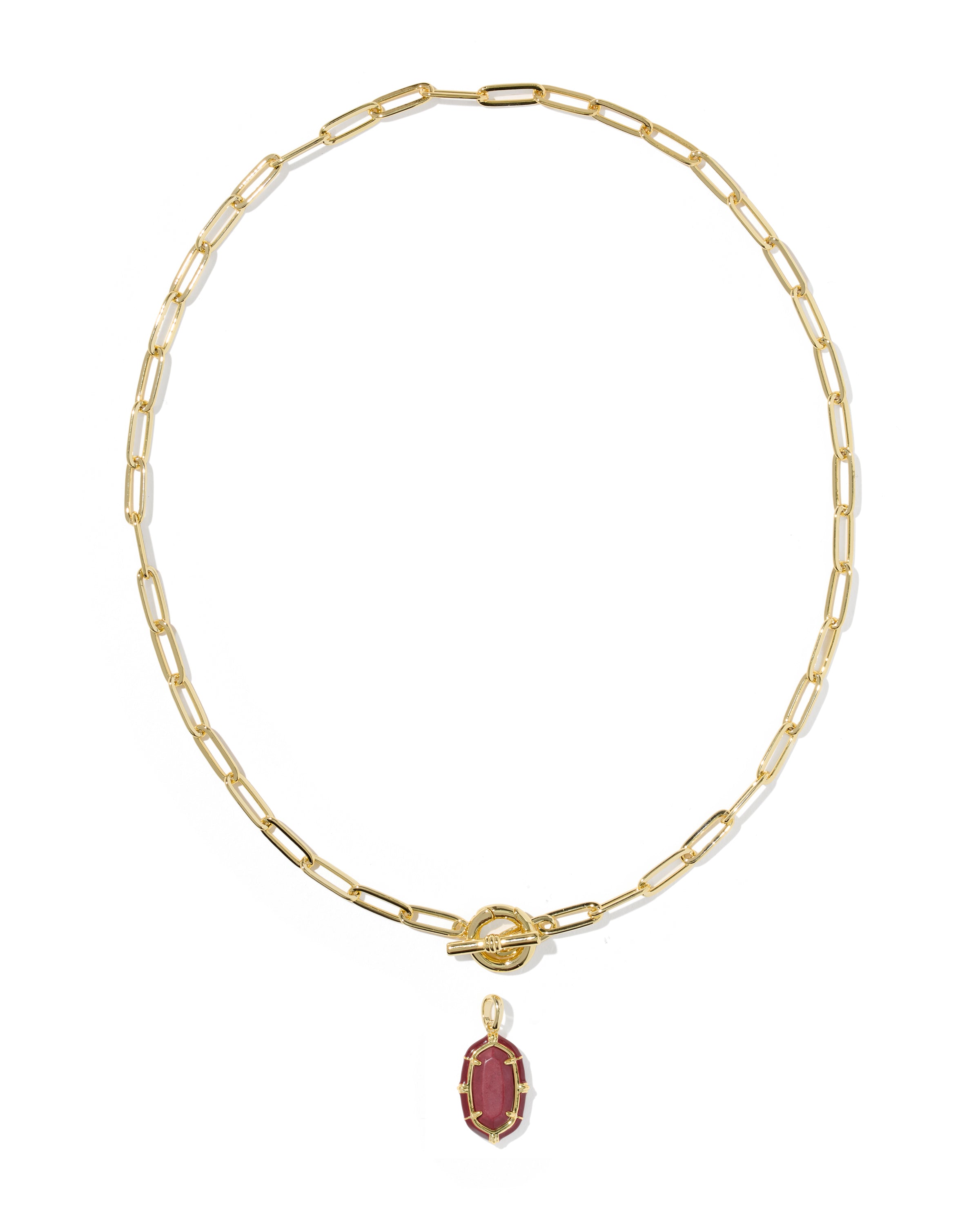 A gold paperclip chain necklace with a toggle clasp and a small oval maroon gemstone pendant, shown on a plain white background.