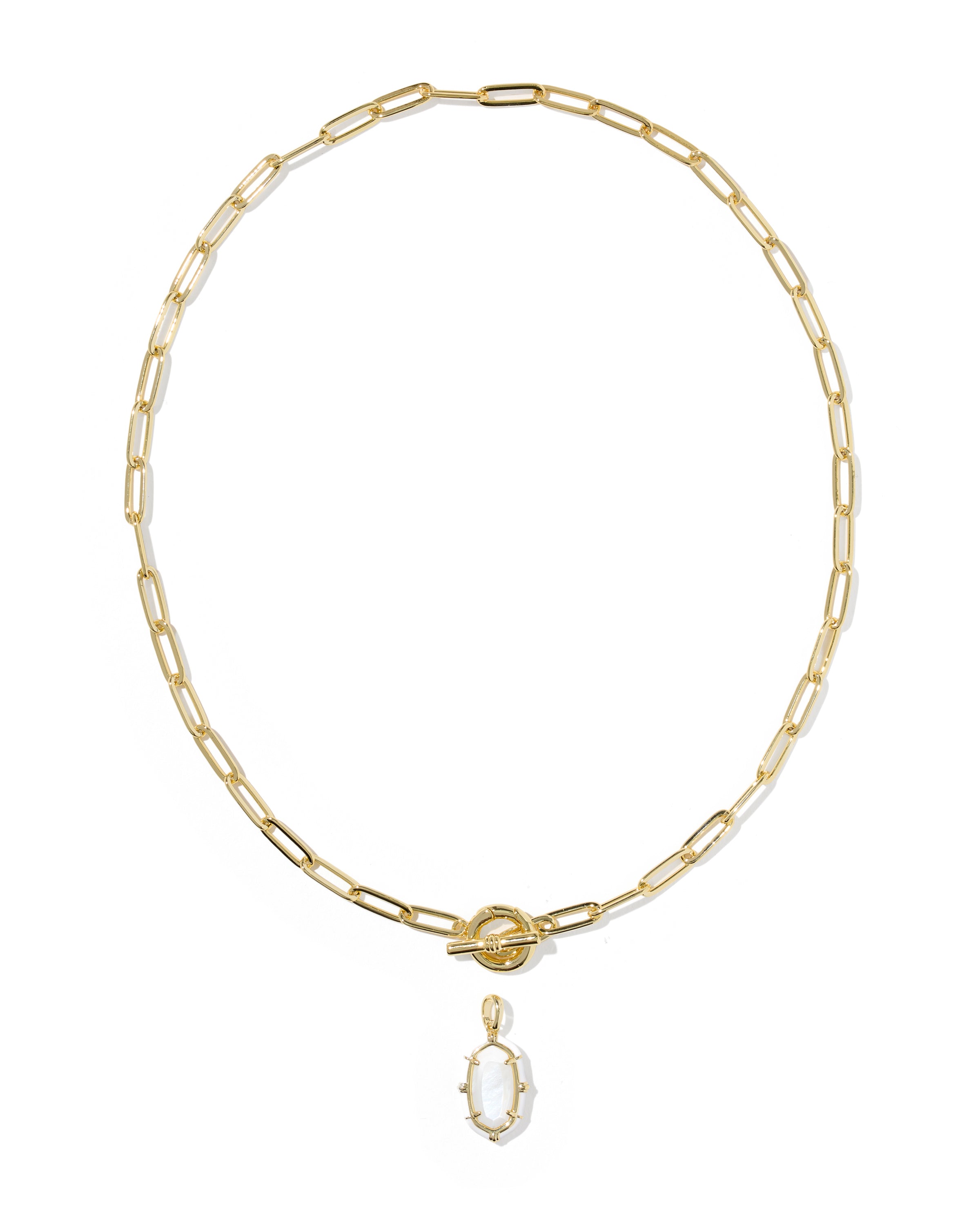 A gold paperclip chain necklace with a small oval pendant featuring a white inlay, displayed on a clean white background.