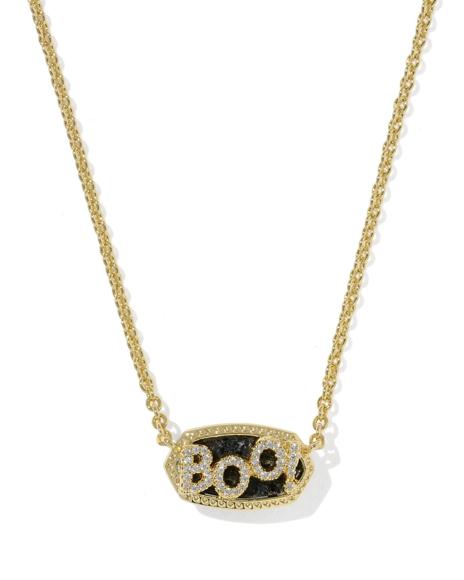 A gold chain necklace with an oval pendant featuring the word 'BOO' in sparkling clear stones over a textured black background, shown on a clean white background.