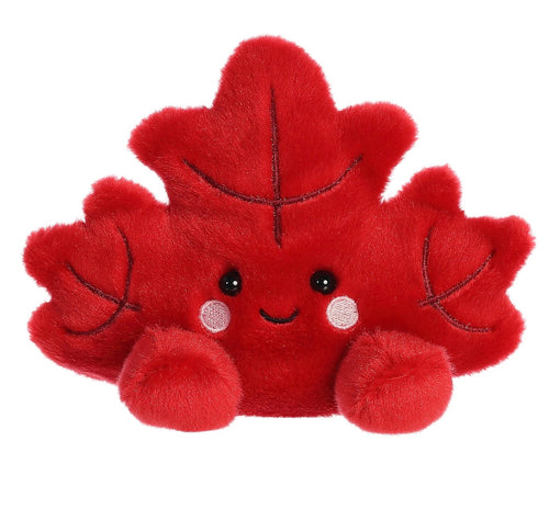 A red plush toy shaped like a cute cartoon maple leaf with embroidered facial features and small leaf-like limbs, shown on a plain white background.