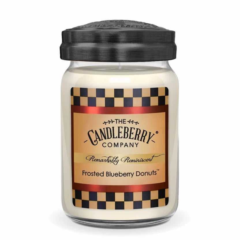 A jar candle with a label reading 'Frosted Blueberry Donuts' from The Candleberry Company.