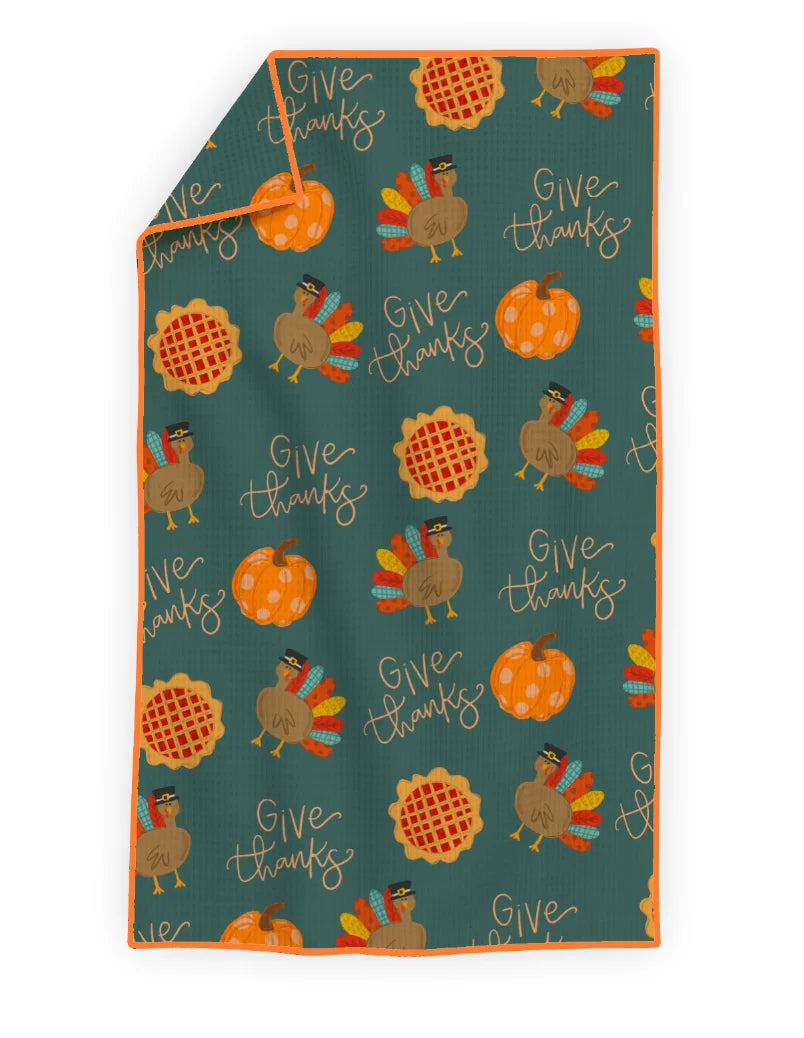 Thanksgiving-themed blanket with turkeys, pumpkins, and waffles on a blue background.