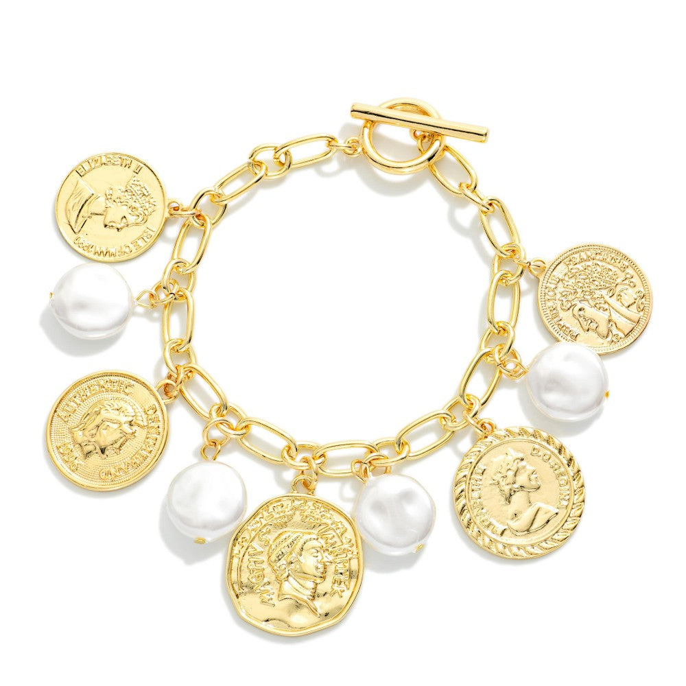 Gold bracelet with coins and pearls on a white background