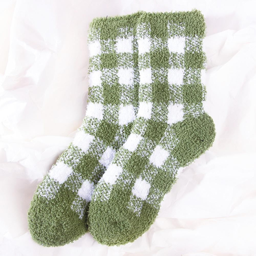 A pair of plush, fuzzy crew socks in an olive green and white gingham checkered pattern, laid flat on a soft white fabric background.