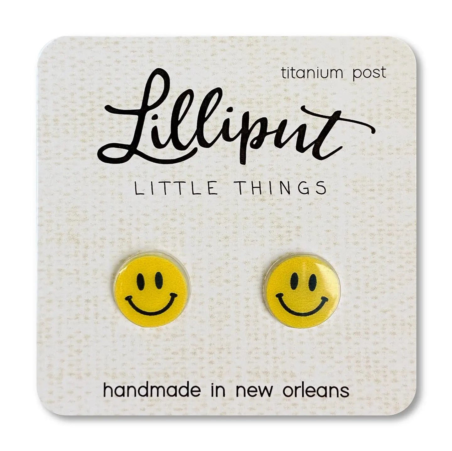 Yellow happy face earrings on a Lilliput Little Things branded card.
