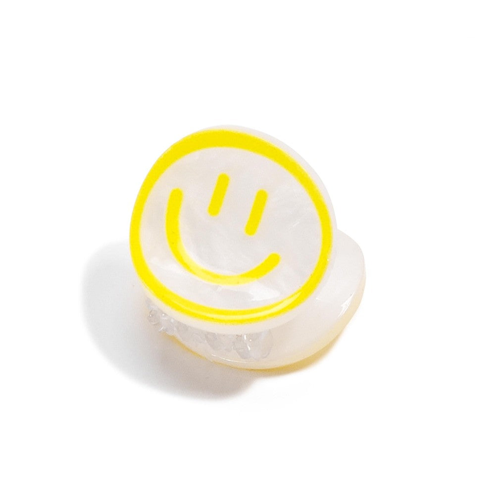 Neon smiley face light on a white background
