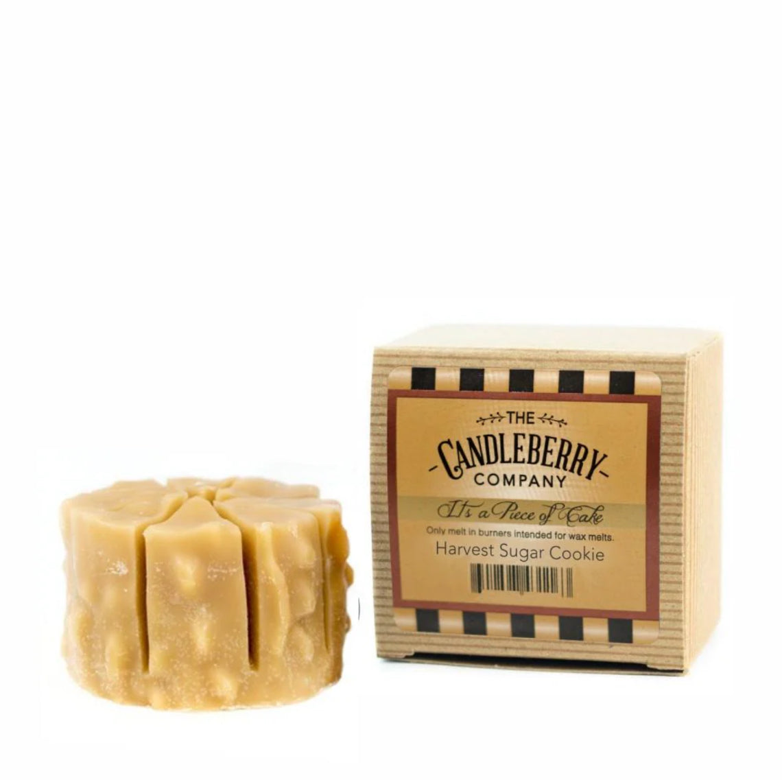 A wax melt designed to resemble a sugar cookie, placed in front of its packaging which reads 'Candleberry Company Harvest Sugar Cookie'.