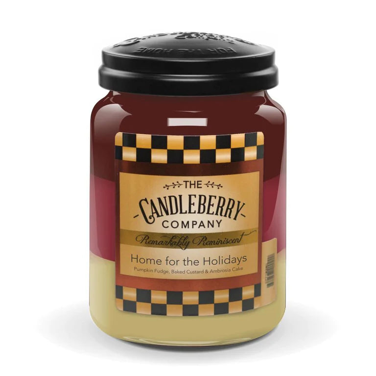 A large jar candle with a red and yellow label that reads 'Home for the Holidays' from The Candleberry Company.