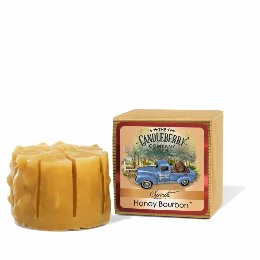 A wax melt in the shape of a tart with a honey bourbon scent, alongside its packaging box which has 'Candleberry Company' branding and an illustration of a blue car.