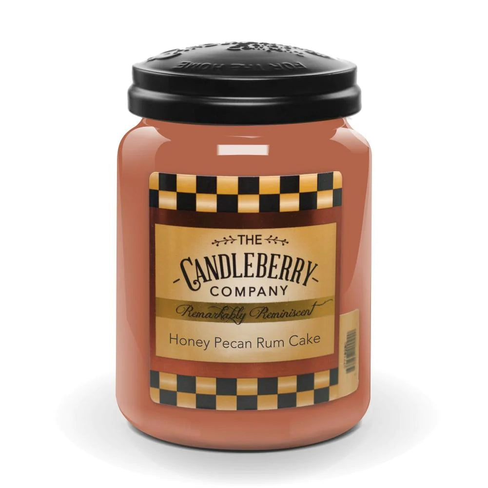 A jar candle with a label reading 'Honey Pecan Rum Cake' from The Candleberry Company.