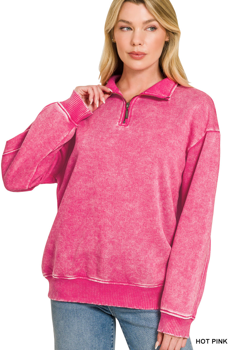 Woman wearing a pink pullover with a zipper on a white background