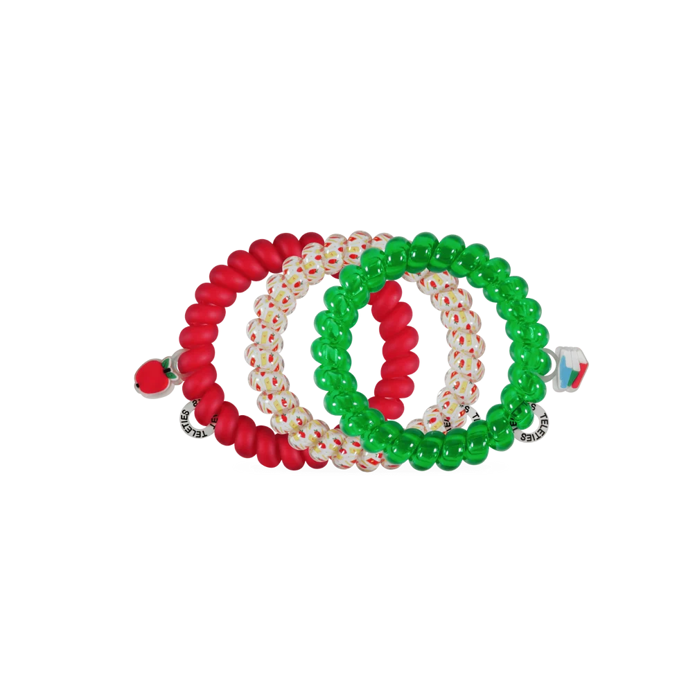 Three beaded stretch hair ties arranged in a circle on a plain white background. One bracelet is solid red, one is translucent white with tiny red and green dots, and one is solid green.
