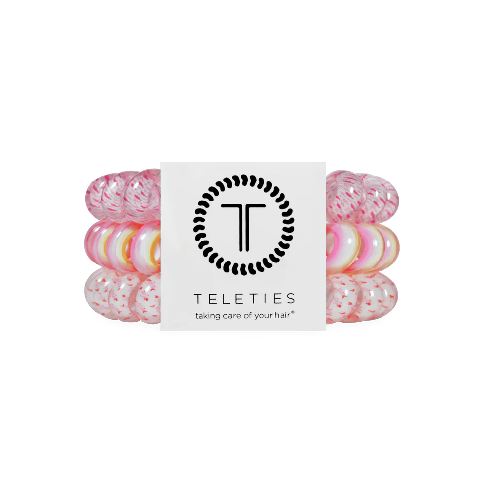 Pack of pink hair ties with a brand label on a white background