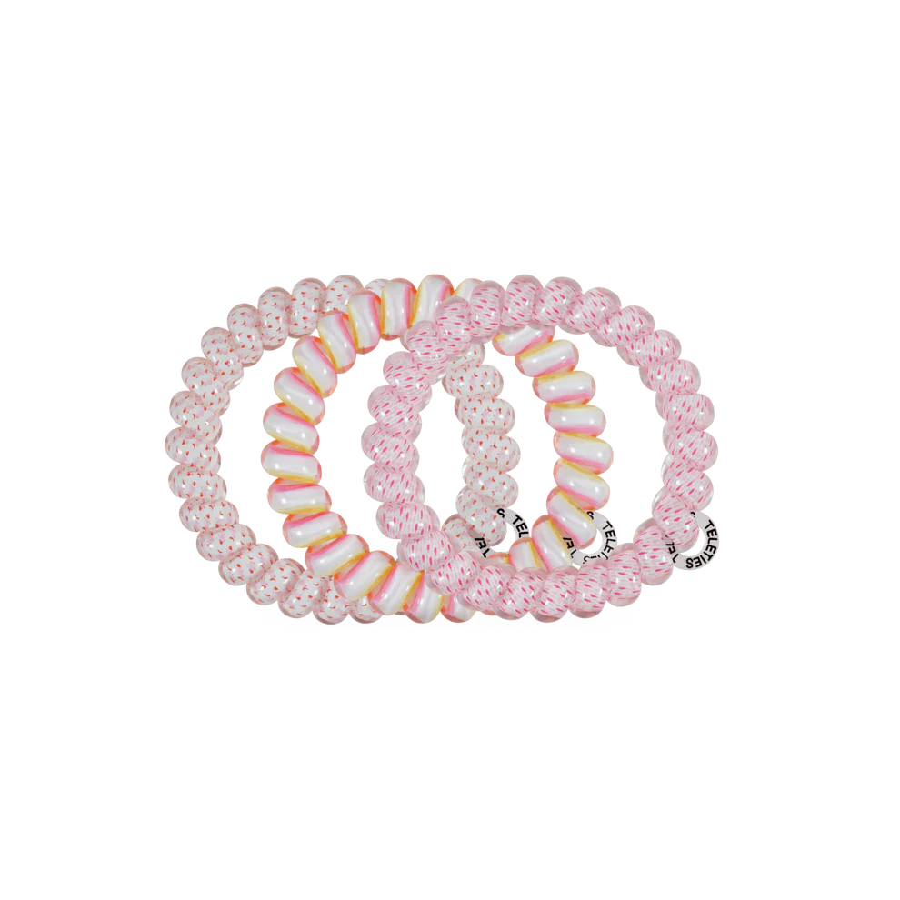 Three pink beaded stretch hair ties arranged overlapping on a plain white background.