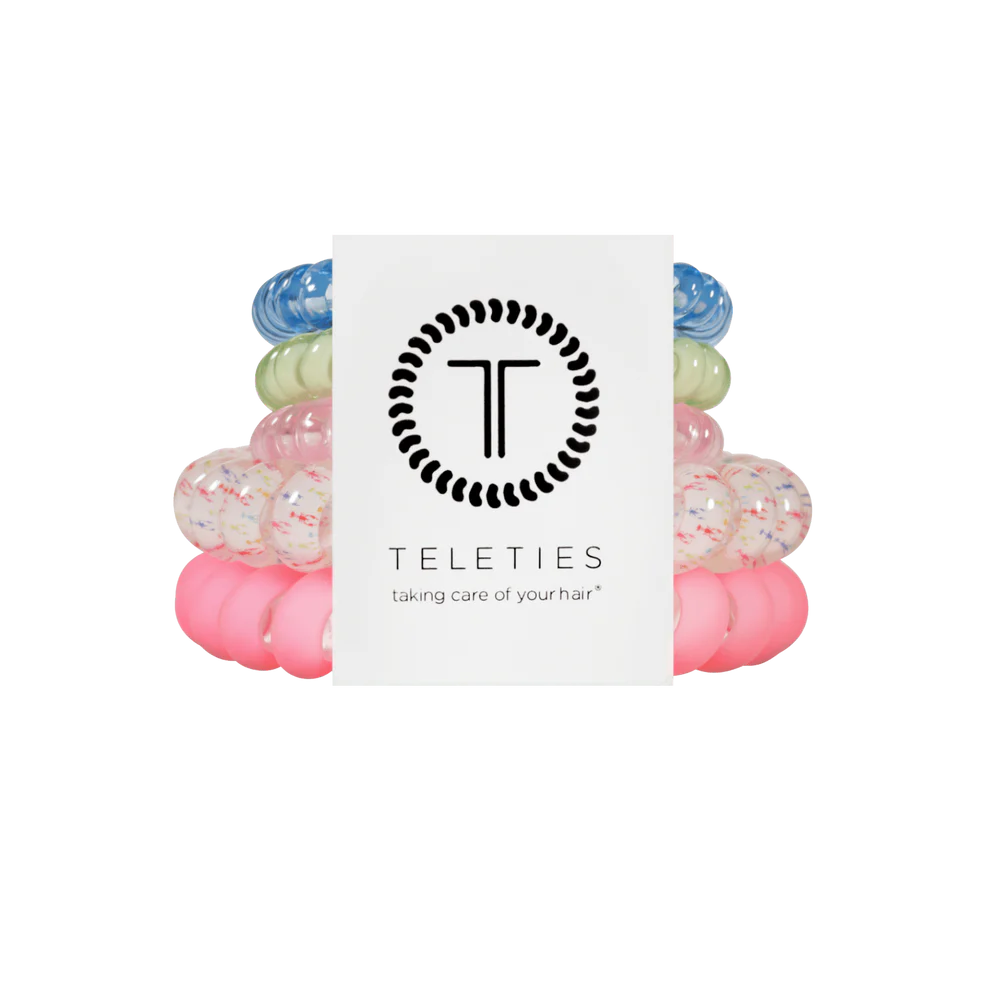 Colorful hair ties stacked with a Teleties branded card on a white background