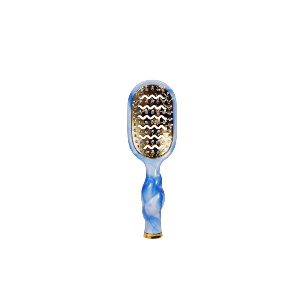 Paddle hairbrush with blue and white marbled handle on a white background