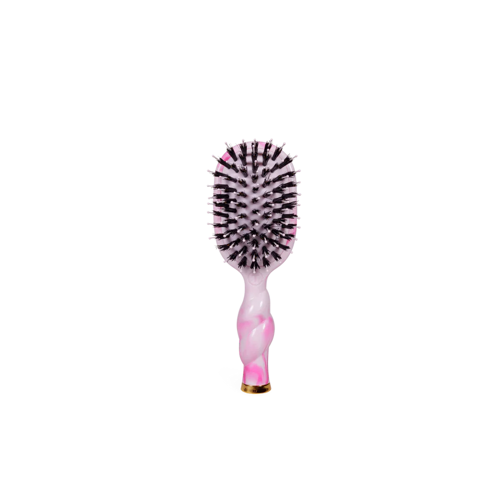 Pink and black hairbrush on a white background